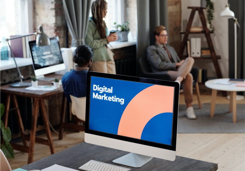 Digital Marketing Services That Drive Real Results displayed on a laptop at QDivision office